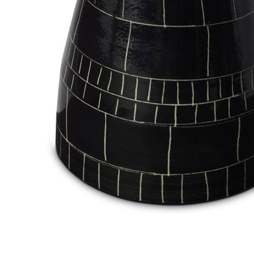Black ceramic vase with white line pattern on a white background Explore the artistry of Wayne Perry with this 6in black and white ceramic vase. Handcrafted and signed, each piece showcases unique sgraffito techniques and film strip inspiration.